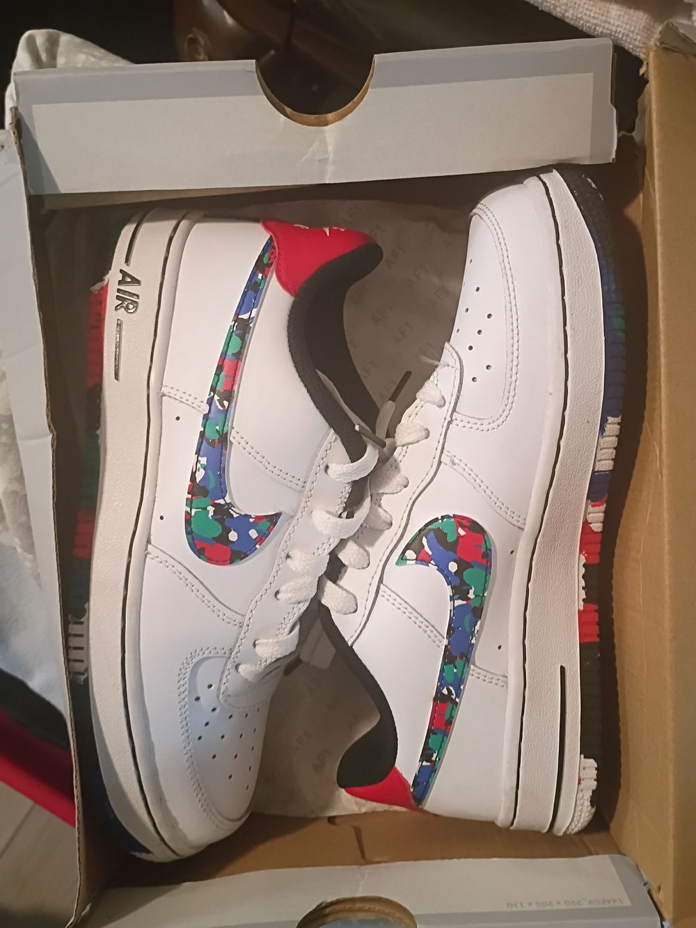Men's Nike White Leather Athletic Shoes with Multicolor Swoosh and Red Heel
